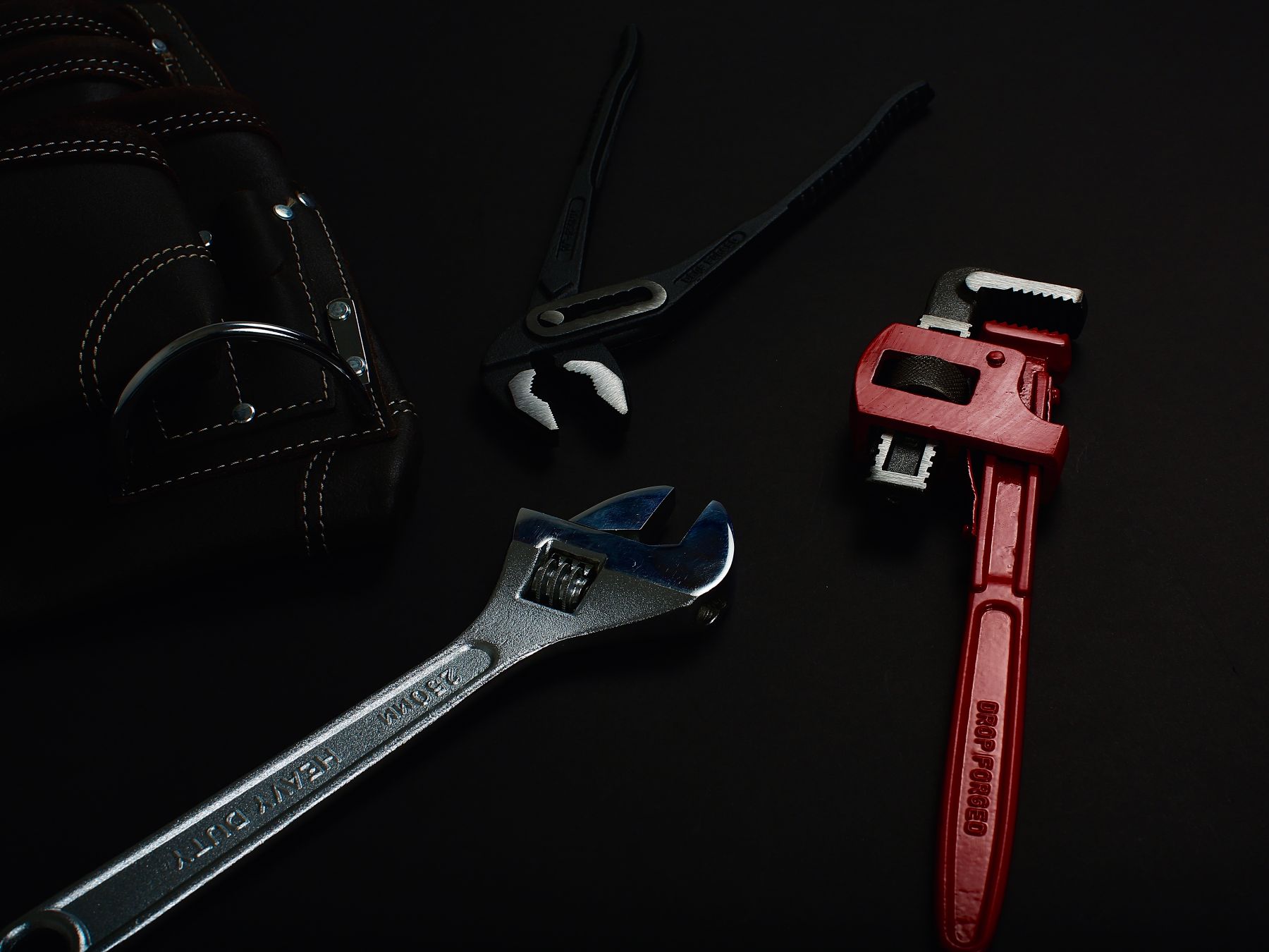 Hand tools on a dark surface
