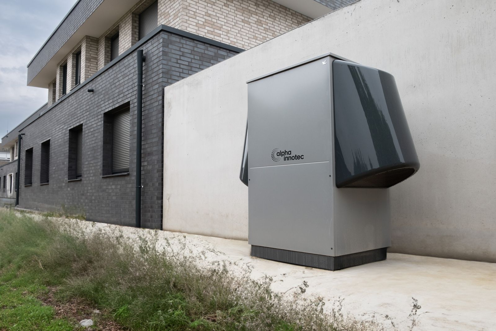 Outdoor heat-pump unit beside a building