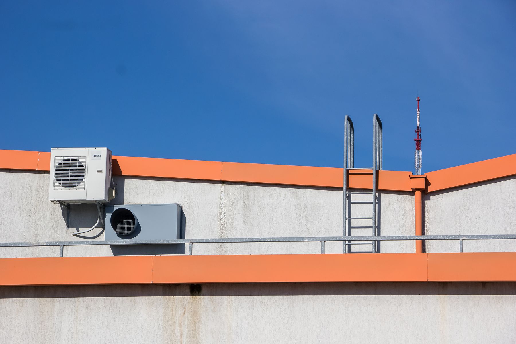 Rooftop air-conditioning equipment beside an access ladder