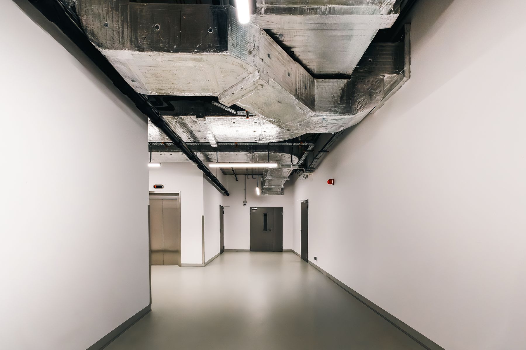 Office interior with exposed overhead ducts