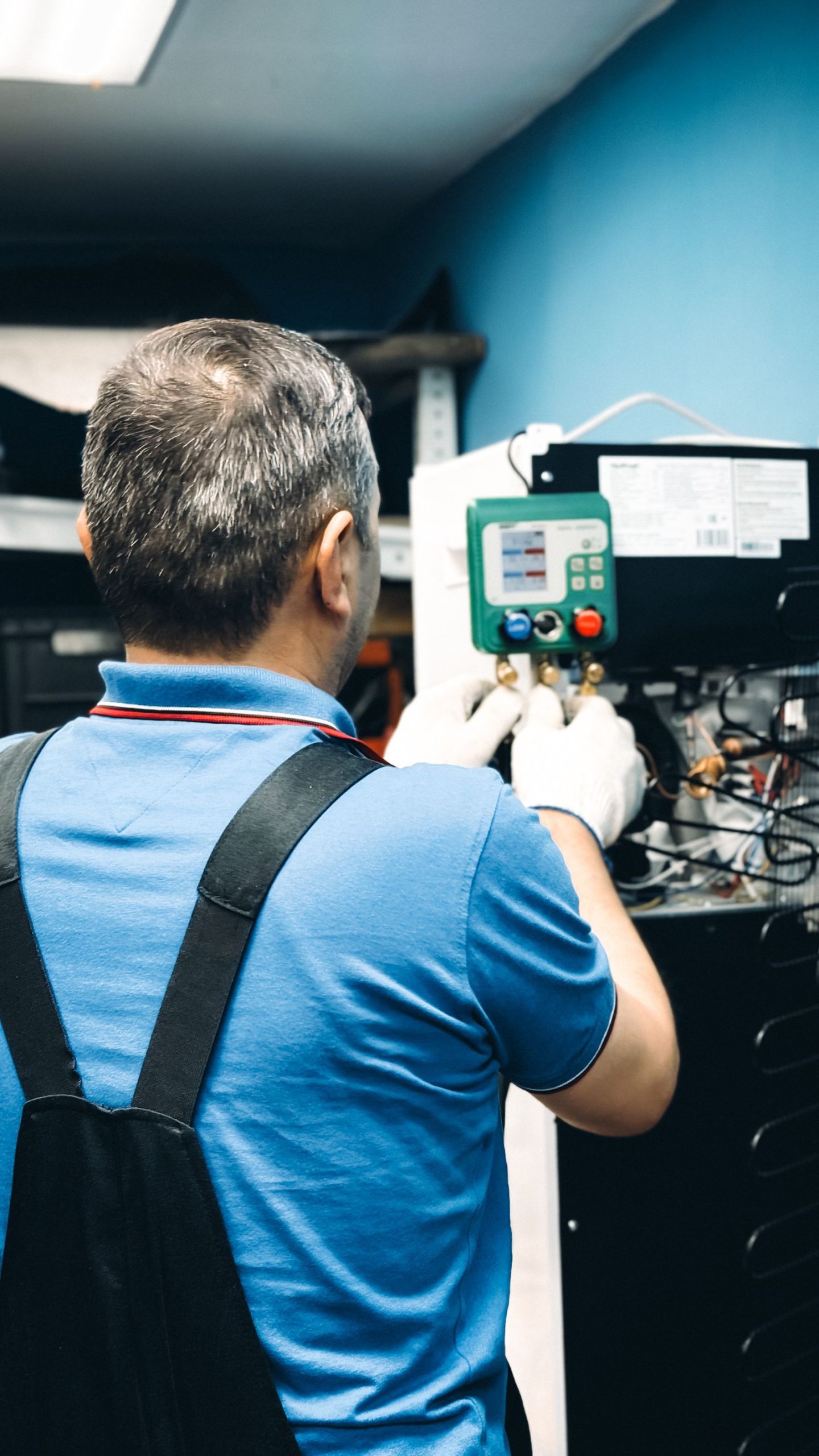 Person working at equipment controls indoors