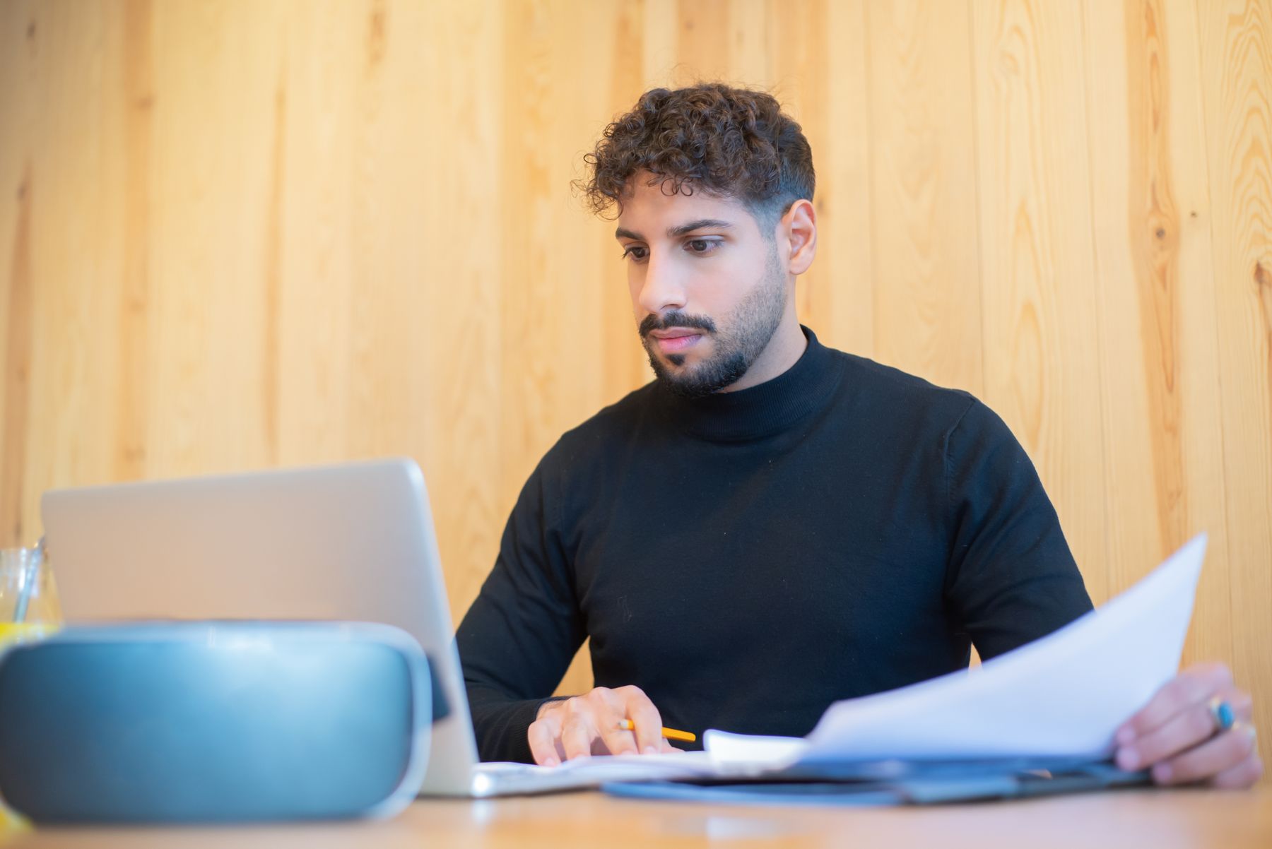 Person reviewing documents at a laptop