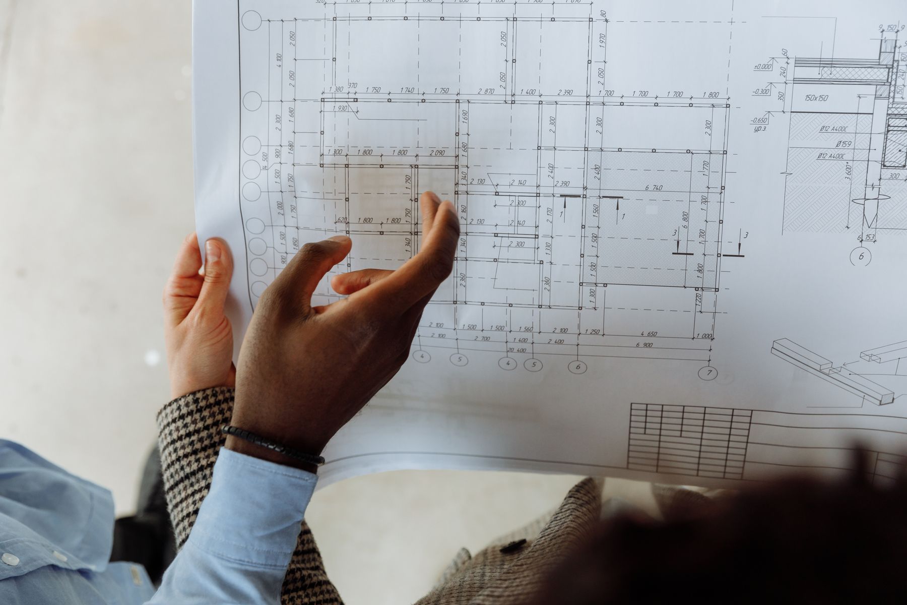 Hands pointing at a building plan
